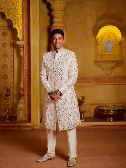Cricketer Suryakumar Yadav looking regal in a custom Abu Jani Sandeep Khosla sherwani. The intricate, all-over embroidery is a testament to the designers' mastery.
