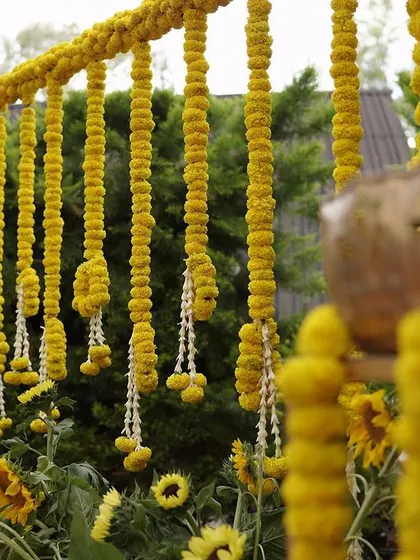 A close-up of the hanging marigold and sunflower decorations, showing the natural beauty and texture of our floral designs.