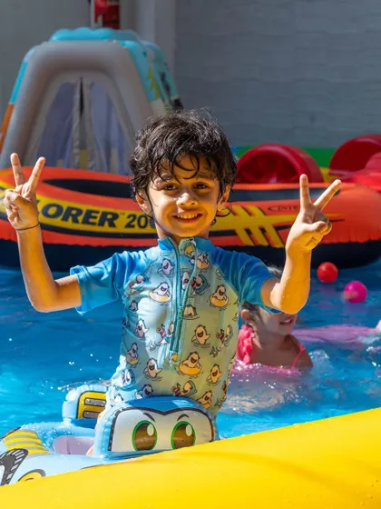 This little boy is giving two thumbs up for our pool parties. It's a guaranteed day of fun.