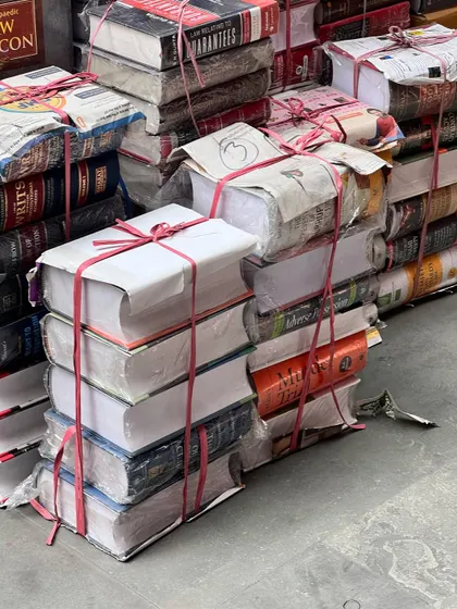 Stacks of law books, ready to be shipped out. This sight is a testament to the ever-growing body of legal knowledge that we as lawyers must constantly engage with.