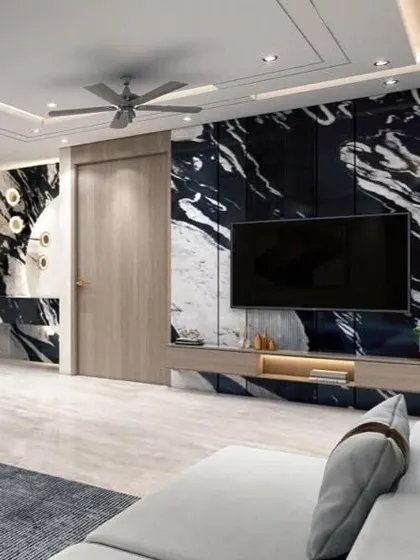 A living room featuring a dramatic Panda White marble cladded wall as the star of the show. This avant-garde design element creates a bold statement and serves as a stunning backdrop for the TV and console.