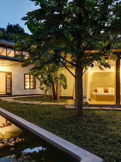 The Garden Suite at dusk, with warm interior lights creating a welcoming glow against the evening sky.