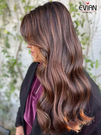 Another angle of this stunning balayage, showing how the side-swept bangs and layers frame the face. The color placement is designed to enhance the client's features.