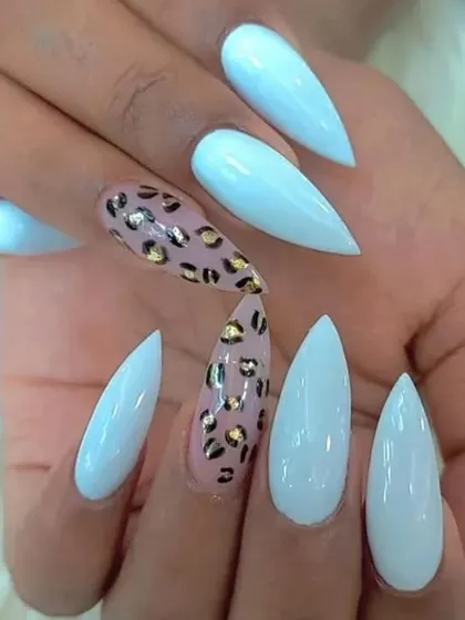 Another take on the popular leopard print trend. This design pairs the hand-painted print with a soft baby blue on sharp stiletto nails.