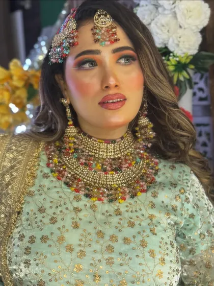 This portrait captures the radiant glow of the Haldi bride. The makeup is designed to look fresh and vibrant, perfect for a daytime celebration.