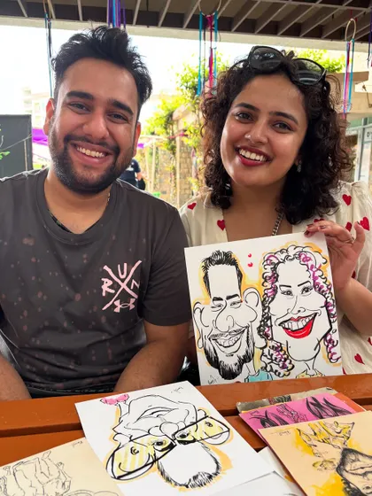 A happy couple at the alumni meetup, showing off their fun portrait.