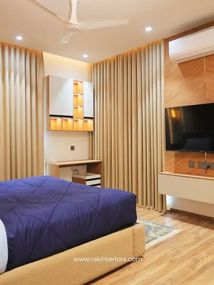 The bedroom with the wood-paneled TV wall, showing the full layout and cozy atmosphere.