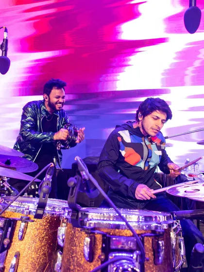 Jamming with the drummer during a live show. My role as a percussionist is to complement the main drum beat, adding layers of rhythmic complexity.