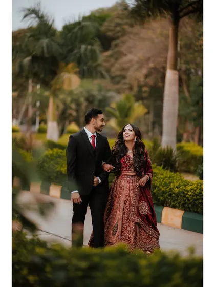 A candid shot of Sushmita and Deepak walking and talking together during their reception.