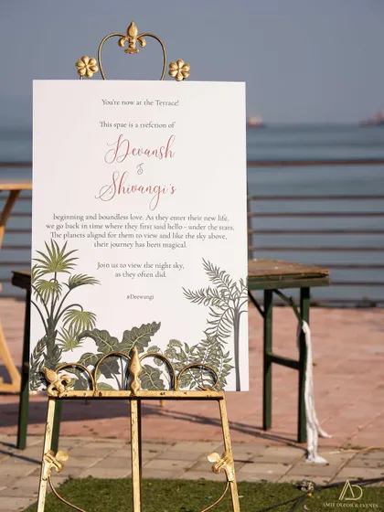 Meaningful details never go out of style. This welcome sign shares a personal message from the couple, set against a beautiful sea view.