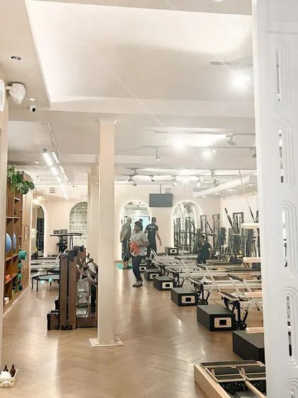 An expansive view of our studio, showcasing the clean lines, organized equipment, and spacious layout that allows for comfortable, focused movement.