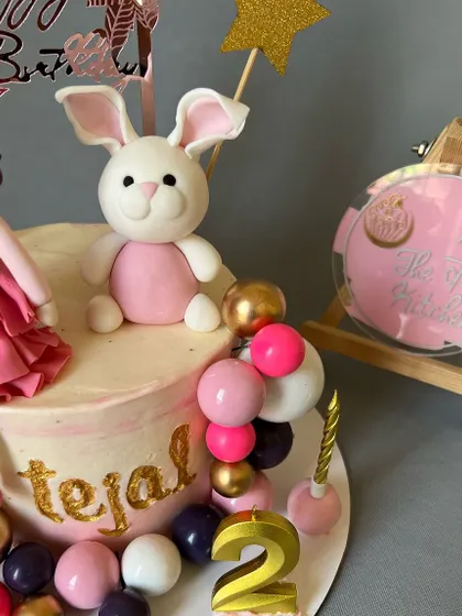 A close-up view of the adorable fondant bunny topper, showing the detailed work that goes into each custom figure.