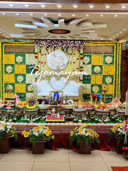 A baby shower setup with a green and yellow marigold checkerboard backdrop, creating a fresh and festive look for the celebration.