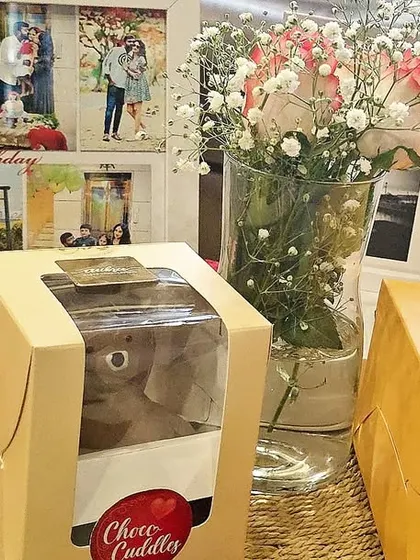 A heartfelt birthday surprise for him, featuring a custom photo collage frame, a delicious chocolate dessert, a bouquet of flowers, and a personal note.