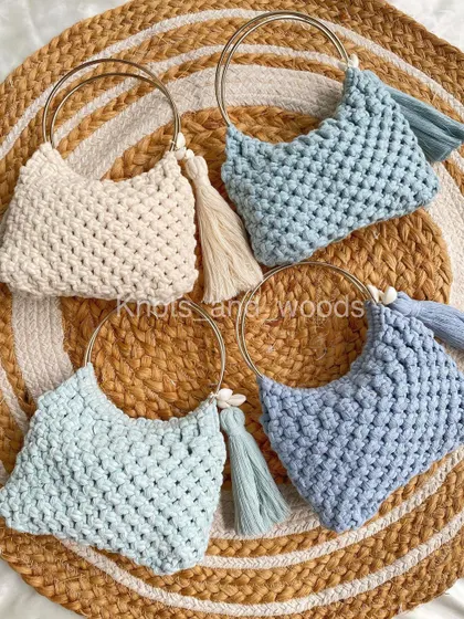 A beautiful collection of my ring handle macrame bags, ready to find their new homes! Pictured here in shades of blue and cream, some with tassels and sea shell details. I can also make these with wooden handles for a different look.