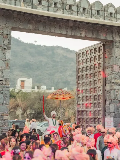 The groom's procession arriving at the magnificent gates of the venue, a truly royal entrance for a king.