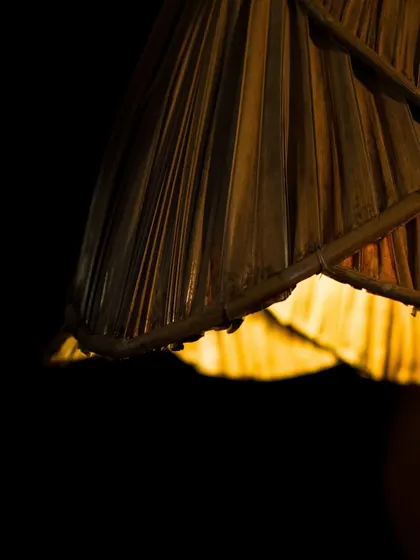 A close-up of the palm leaf lamp's edge. The natural texture and gentle fraying of the dried leaves add to its rustic charm and organic appeal.