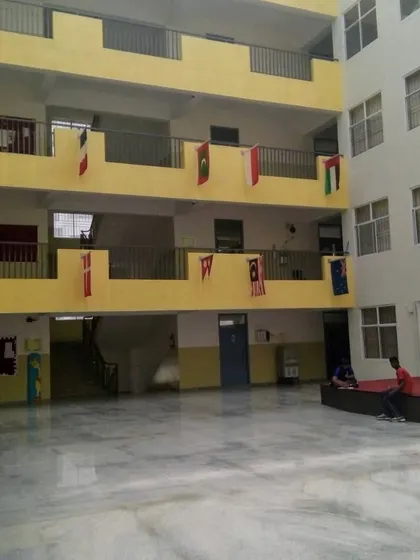 The interior courtyard of Asia Pacific World School, providing a secure and open area for student assembly and recreation.
