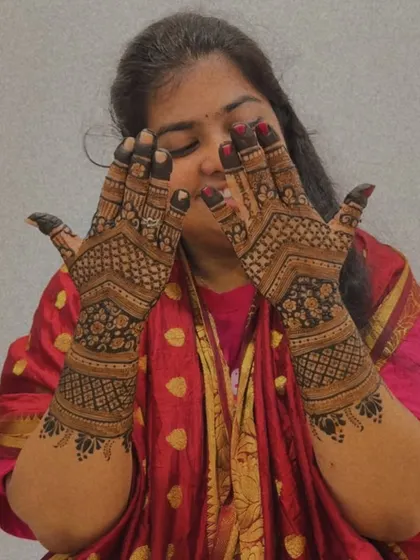 A happy client showing off her intricate back-hand mehendi. It’s moments like these that make my work so rewarding.