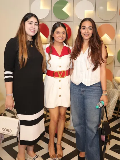A group of stylishly dressed guests enjoying the party.