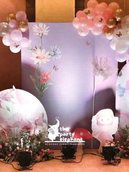 This photo highlights the custom-printed backdrops and whimsical props used to create a photo-worthy corner at the baby welcome party.