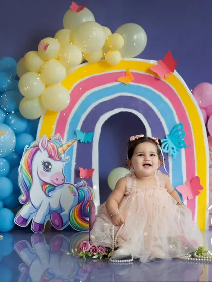 A big, happy laugh from the birthday girl. Our colorful unicorn and rainbow first birthday setup is designed to bring out the brightest smiles.