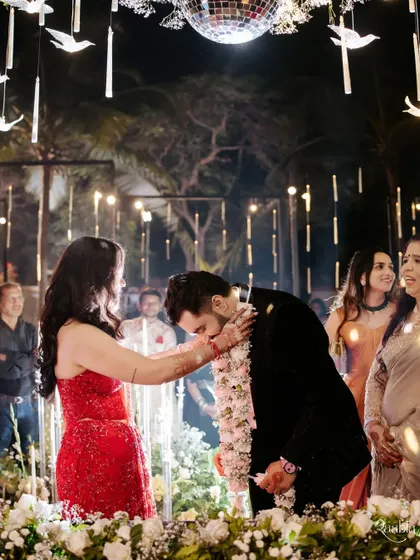 The varmala exchange during Viraj and Palak's wedding, a key moment of union under a canopy of lights and a disco ball.