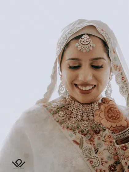 A joyful, smiling close-up of a Muslim bride, her happiness radiating from the frame.