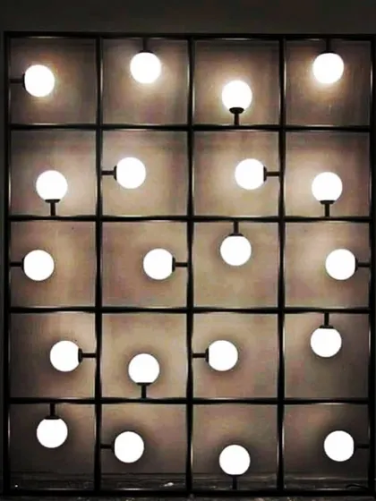 This rectangular grid of lights is a simple but effective backdrop. It provides a modern, industrial-chic vibe and ensures everyone is perfectly lit for photos.
