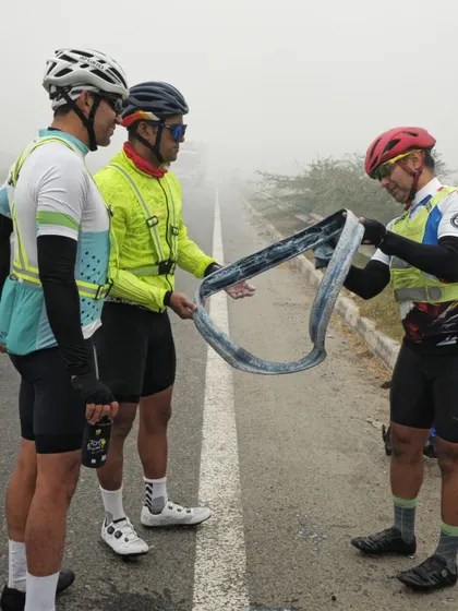 Teamwork in action. Riders helping fix a tire during a foggy BRM. In randonneuring, you are never truly alone.