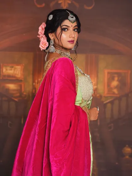 A regal portrait as a Maratha queen, looking away from the camera. This angle highlights the elaborate hairstyle, the velvet shawl, and the rich layering of the costume.