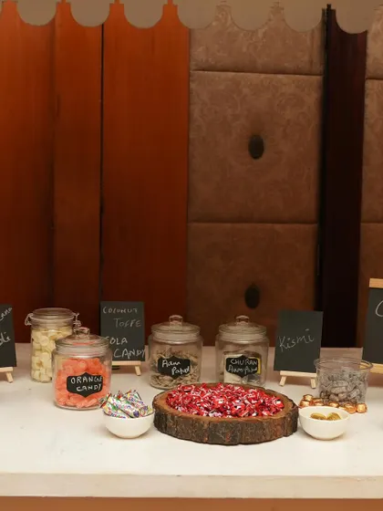 A close-up of the nostalgic candy selection on the 'Bachpan Ki Yaadein' cart, featuring old-school favorites in glass jars.