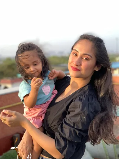 Enjoying the weekend weather from the balcony with my daughter.