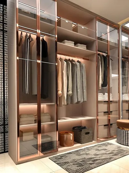 This walk-in closet with rose gold accents and glass doors is the epitome of modern elegance. It’s a space designed not just for storage, but for inspiration.