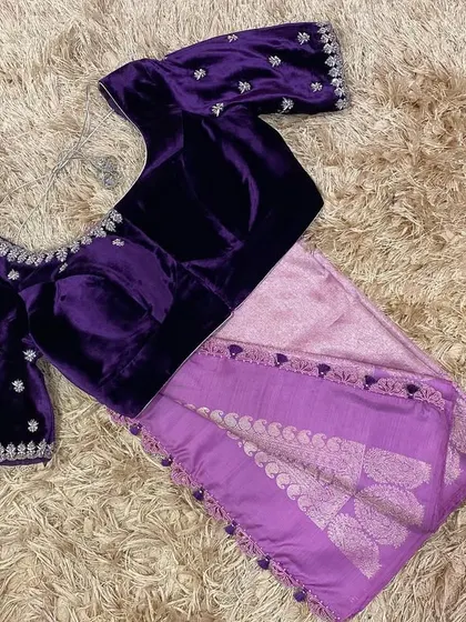 The front view of the velvet violet blouse, showing the simple yet elegant embroidery along the neckline.