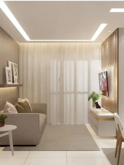 A cozy living room setup with a simple sofa and a floating TV unit against a wood-paneled wall. The sheer curtains allow natural light to fill the room, creating a warm and inviting atmosphere.