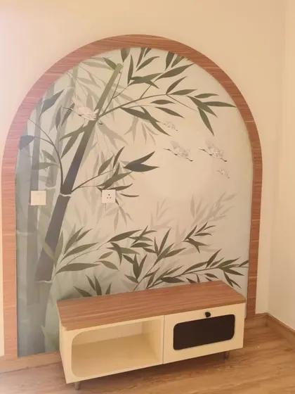 A minimalist bamboo and bird mural inside an arched niche, bringing a touch of Zen-inspired tranquility to the room.