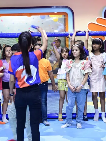 A group of kids participates in a guided game with an instructor, showcasing our engaging group activities.
