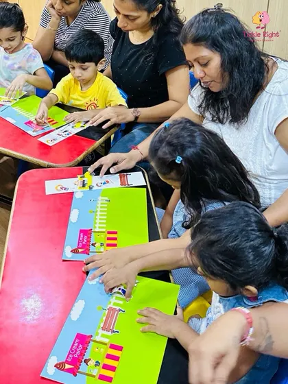 Children and their mothers are all smiles as they work on a puzzle together. Our classes are a wonderful opportunity for parent-child bonding.