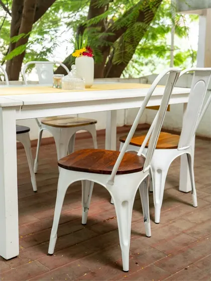 A wider view of the modern outdoor dining set, showing four chairs neatly arranged around the table. The clean lines and mixed materials make it a versatile choice for any contemporary outdoor space.