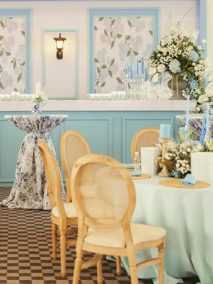 A sophisticated English-themed engagement party with a blue and white color palette, featuring elegant furniture, chinoiserie-print fabrics, and classic floral arrangements.
