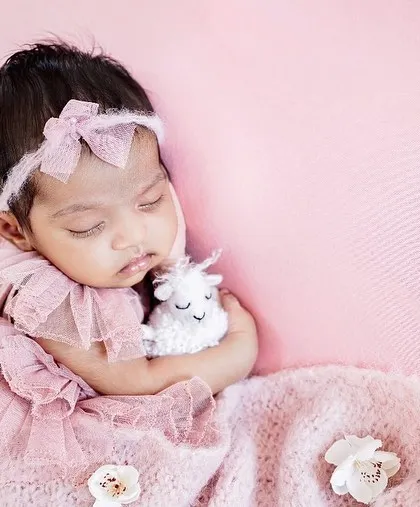 Pretty in pink. This little darling is sleeping so sweetly with her tiny lamb toy. I have a wide selection of outfits and props to match any color scheme you love.