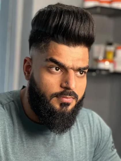 A front view of this bold style. The full, well-groomed beard is a key part of this powerful look.