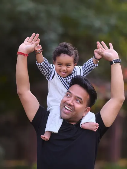 A fun ride on dad's shoulders. This pose always brings out the biggest smiles and is a wonderful way to capture the fun-loving bond between a father and his child.