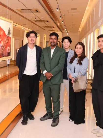 The artist with a group of guests at the 'Ethereal Charm' exhibition.