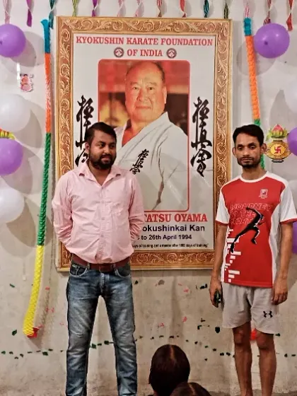 Posing with a senior student during our dojo's anniversary. These celebrations are a time to reflect on our journey.