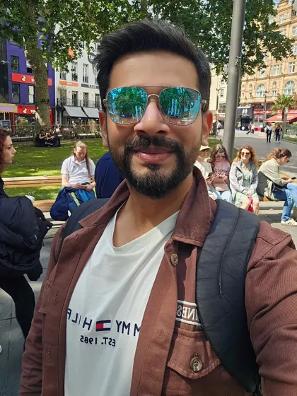 A bright, sunny selfie from a day out in London. The direct eye contact and smile create an engaging image for social media or digital advertising.