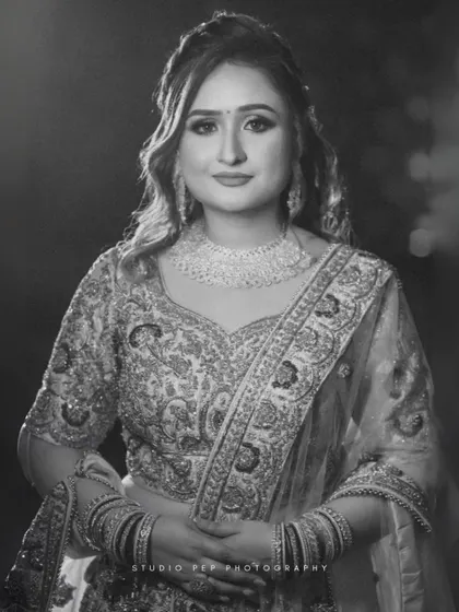 A timeless black and white bridal portrait of Shivani. Her elegant lehenga, intricate jewelry, and serene expression are captured in classic, monochrome beauty.