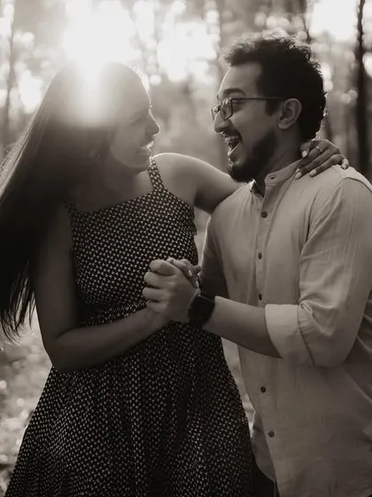Anjum and Soham dancing in the woods, with the sunlight filtering through the trees. This black and white image is full of movement, joy, and beautiful natural light.
