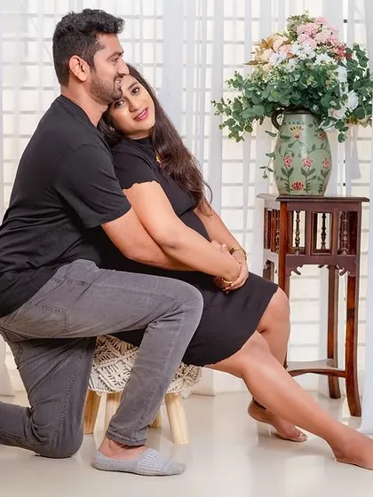 A loving embrace from behind. This couple's portrait in casual black outfits is intimate, comfortable, and timeless.